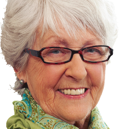 Elderly woman with short gray hair, glasses, and a green scarf, smiling at the camera.